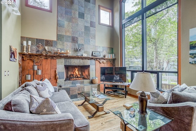 3360 NW Oceanview Dr, Newport, OR 97365 - living room with wood finished floors, a tiled fireplace, and a high ceiling