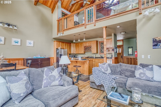 3360 NW Oceanview Dr, Newport, OR 97365 - living room featuring high vaulted ceiling, light wood-style flooring, beam ceiling, and ceiling fan