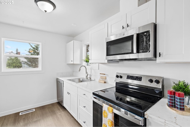 3235 SE 69th Ave, Portland, OR 97206 - kitchen featuring stainless steel appliances and white cabinetry
