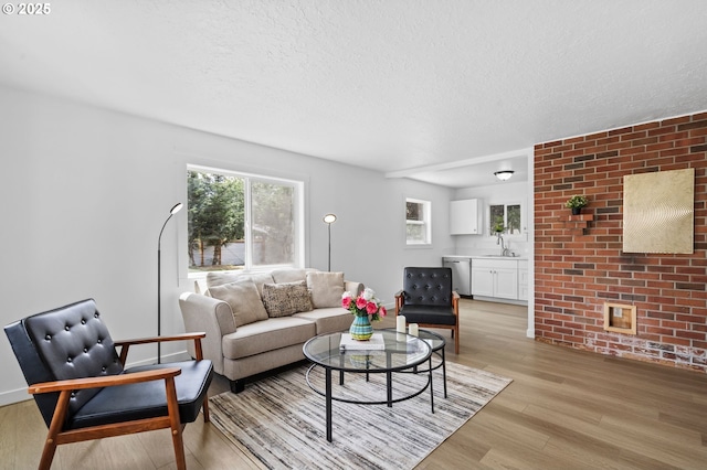 3235 SE 69th Ave, Portland, OR 97206 - living area featuring light wood-style flooring and a textured ceiling