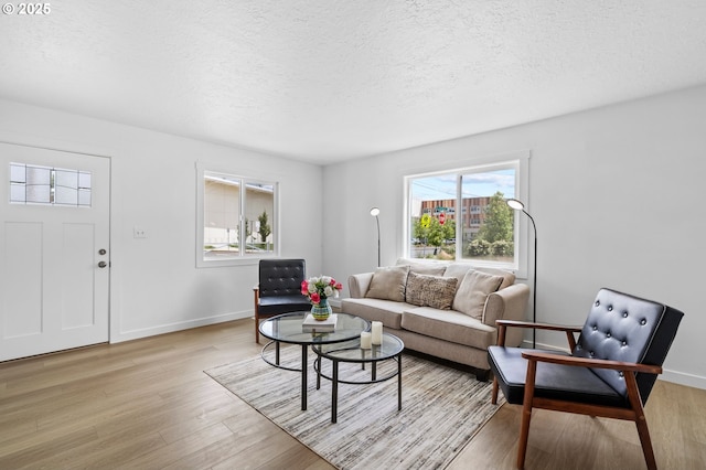3235 SE 69th Ave, Portland, OR 97206 - living area featuring light wood-style floors and a textured ceiling