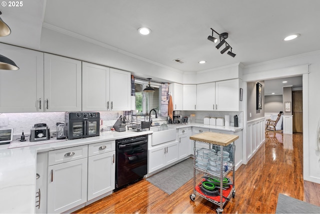 190 Walnut St, Myrtle Creek, OR 97457 - kitchen with dishwasher, a sink, crown molding, white cabinets, and light countertops
