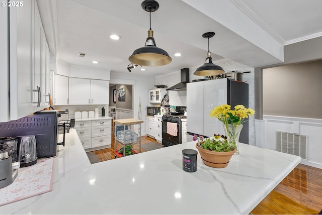 190 Walnut St, Myrtle Creek, OR 97457 - kitchen featuring black gas stove, ornamental molding, freestanding refrigerator, decorative backsplash, and white cabinets
