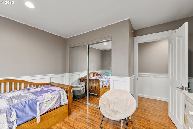 190 Walnut St, Myrtle Creek, OR 97457 - bedroom featuring wood finished floors, wainscoting, a decorative wall, a closet, and recessed lighting