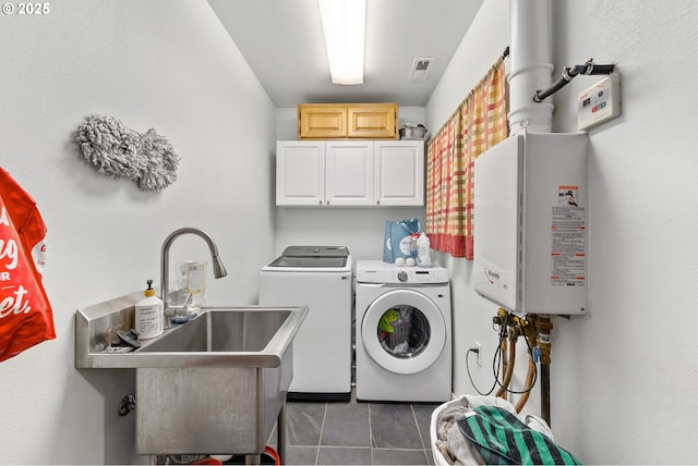 190 Walnut St, Myrtle Creek, OR 97457 - washroom featuring cabinet space, washing machine and clothes dryer, tile patterned floors, and tankless water heater