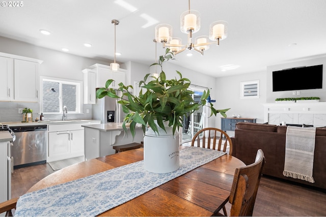 dining area featuring a chandelier, dark wood finished floors, and recessed lighting