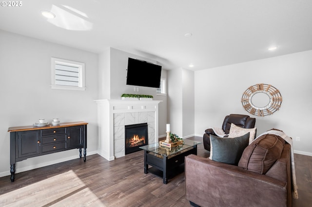 living area featuring a fireplace, baseboards, dark wood-style flooring, and recessed lighting