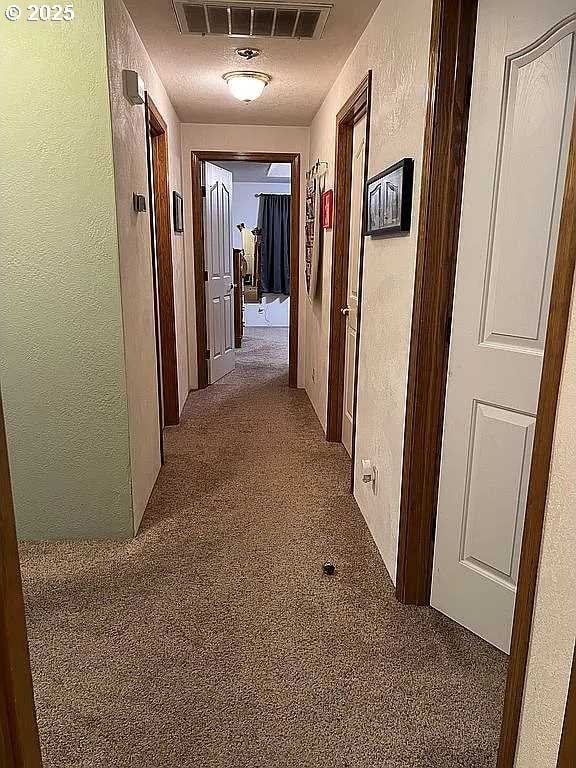 hallway featuring carpet