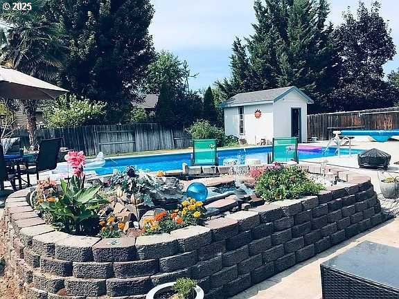 view of pool featuring a patio area and an outdoor structure