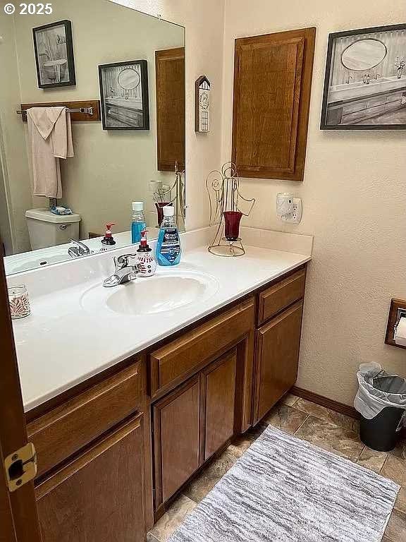 bathroom featuring toilet and vanity