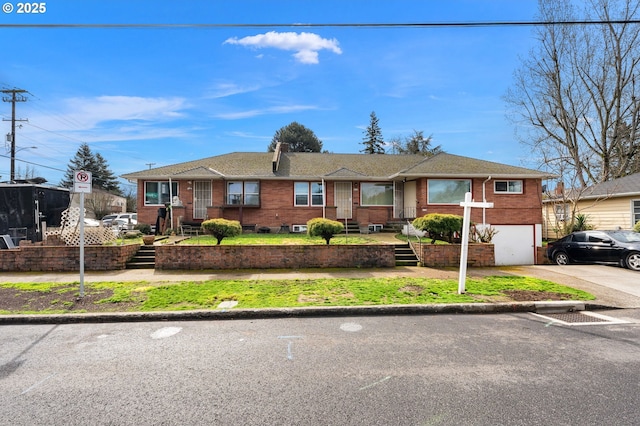 ranch-style house with brick siding, concrete driveway, and a garage