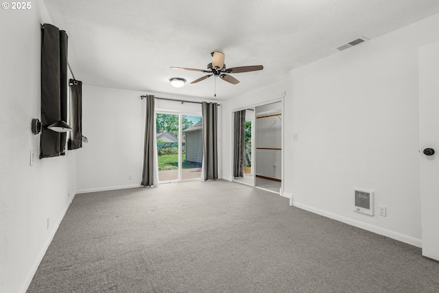 unfurnished room with baseboards, ceiling fan, and carpet floors