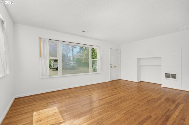 empty room with light wood-style floors and baseboards