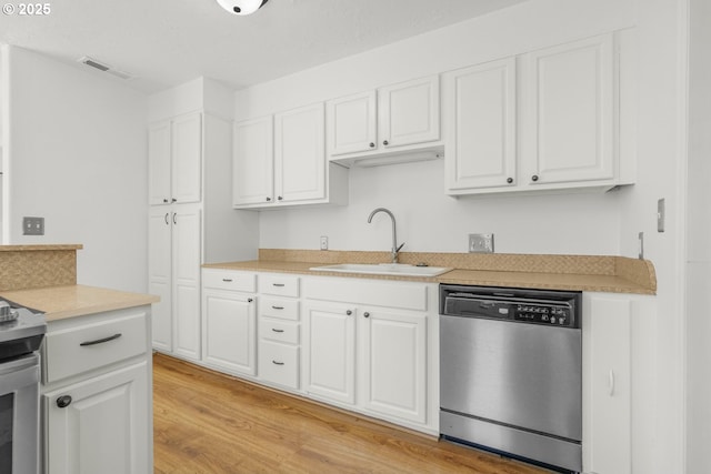 kitchen with dishwasher, a sink, light wood-type flooring, white cabinets, and light countertops
