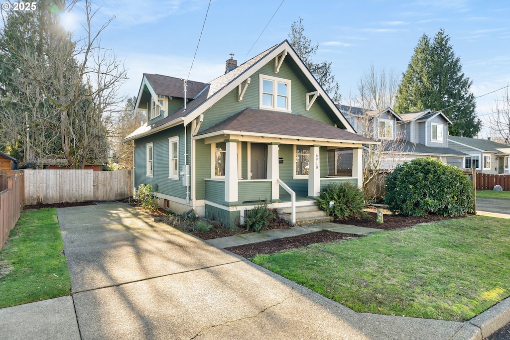 bungalow featuring a front yard and covered porch