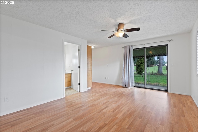 unfurnished room with a textured ceiling, baseboards, light wood finished floors, and ceiling fan