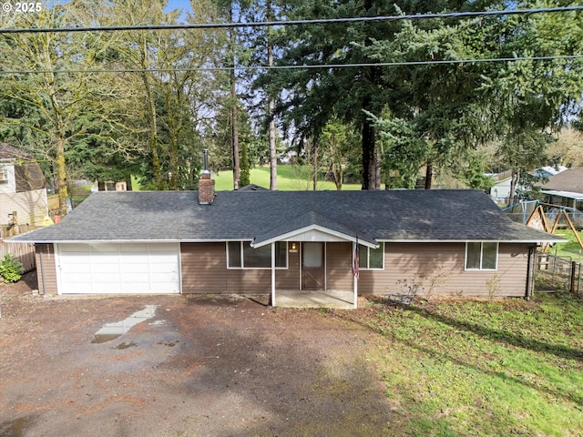 single story home featuring an attached garage, fence, driveway, and a shingled roof