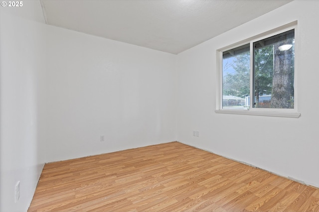 spare room with light wood-type flooring