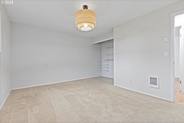 spare room featuring carpet flooring, baseboards, and visible vents