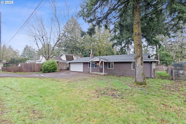 ranch-style house with a garage, driveway, a front lawn, and fence