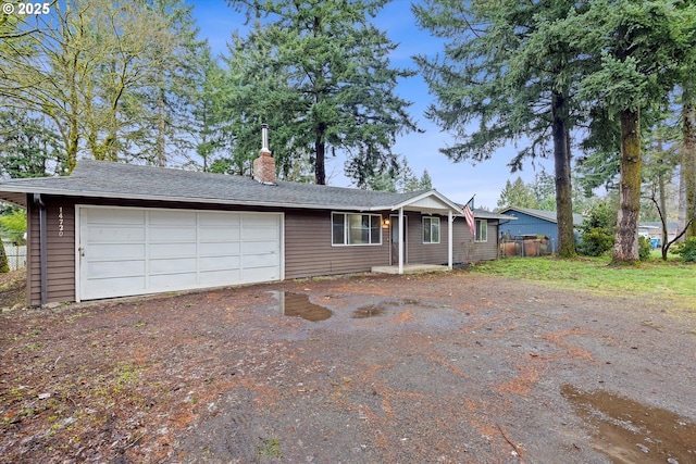 single story home with fence, a garage, driveway, and a chimney