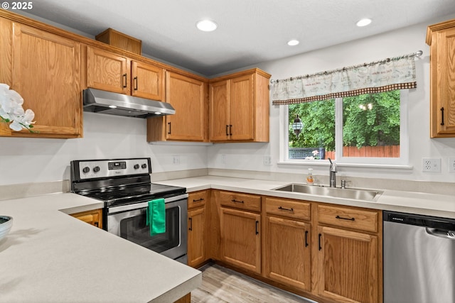 3191 Zinnia St, Eugene, OR 97404 - kitchen with stainless steel appliances, under cabinet range hood, light countertops, and recessed lighting