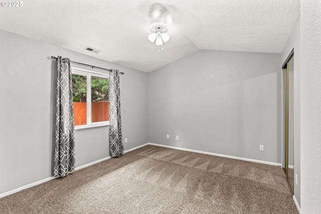 3191 Zinnia St, Eugene, OR 97404 - unfurnished room with carpet, vaulted ceiling, ceiling fan, and a textured ceiling