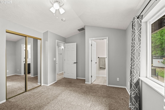 3191 Zinnia St, Eugene, OR 97404 - unfurnished bedroom featuring lofted ceiling, a closet, multiple windows, carpet floors, and ensuite bath