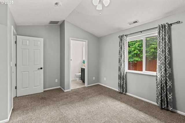3191 Zinnia St, Eugene, OR 97404 - unfurnished bedroom with lofted ceiling, carpet flooring, ensuite bathroom, and a textured ceiling