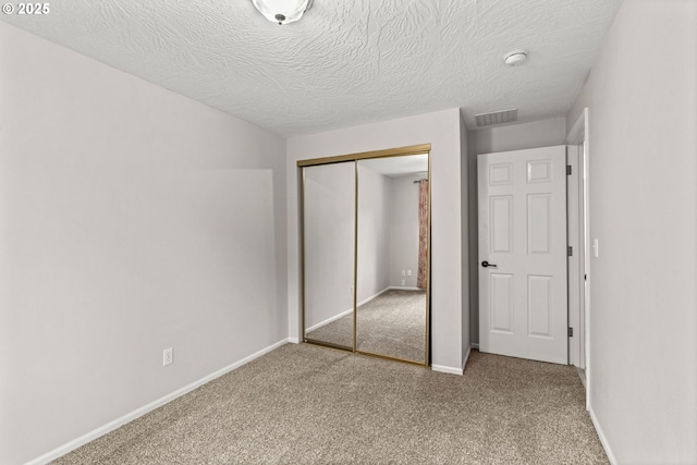 3191 Zinnia St, Eugene, OR 97404 - unfurnished bedroom with carpet, a closet, and a textured ceiling