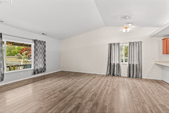 3191 Zinnia St, Eugene, OR 97404 - unfurnished living room with wood finished floors, a ceiling fan, and vaulted ceiling