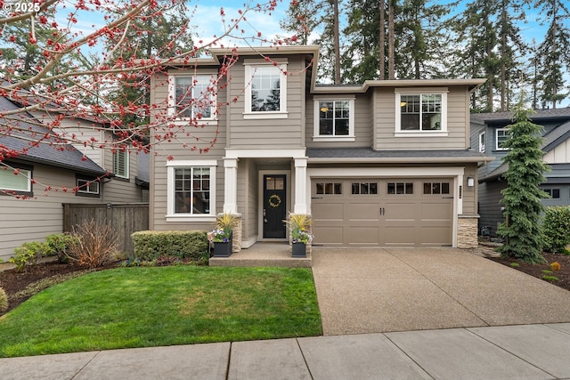 view of front facade with concrete driveway, a garage, fence, and a front yard