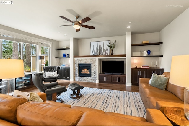 living room featuring a fireplace, recessed lighting, wood finished floors, and a ceiling fan