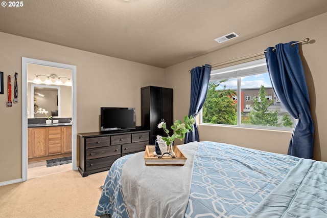 17011 SW Red Leaf Pl, Sherwood, OR 97140 - bedroom with light colored carpet, ensuite bath, a textured ceiling, and baseboards