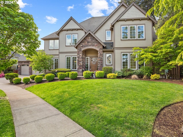 craftsman-style home with stone siding, roof with shingles, and a front lawn