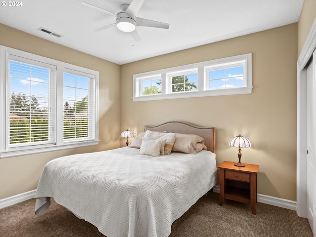 carpeted bedroom with ceiling fan and a closet