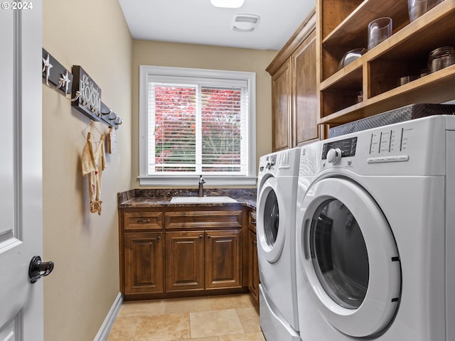 washroom featuring sink, cabinets, and washer and dryer