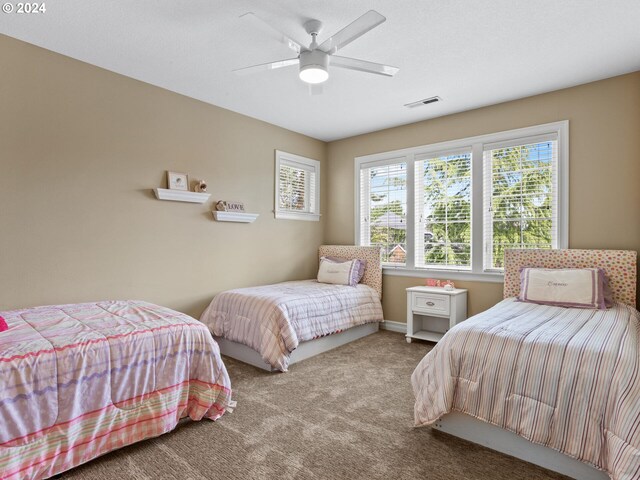 bedroom with ceiling fan and carpet