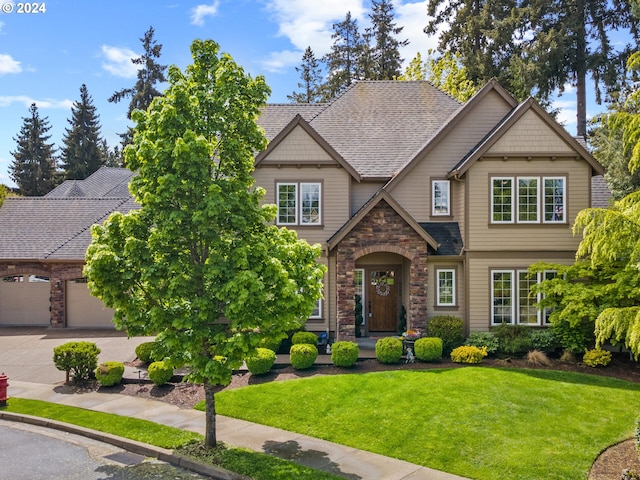 craftsman-style house featuring a front lawn, stone siding, roof with shingles, concrete driveway, and an attached garage