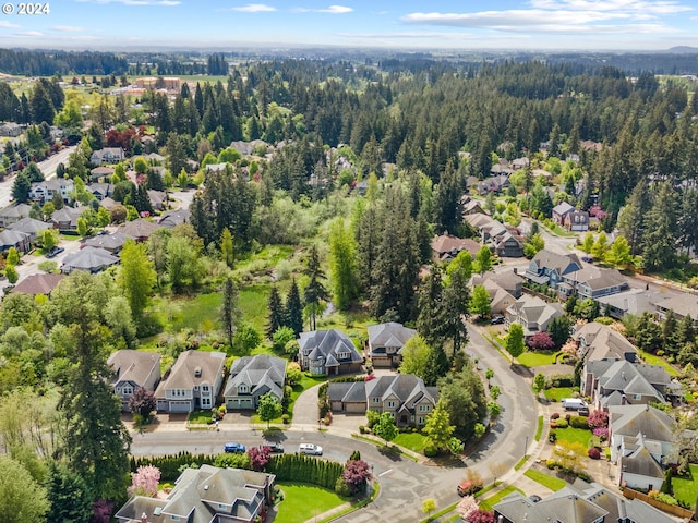 aerial view featuring a forest view and a residential view