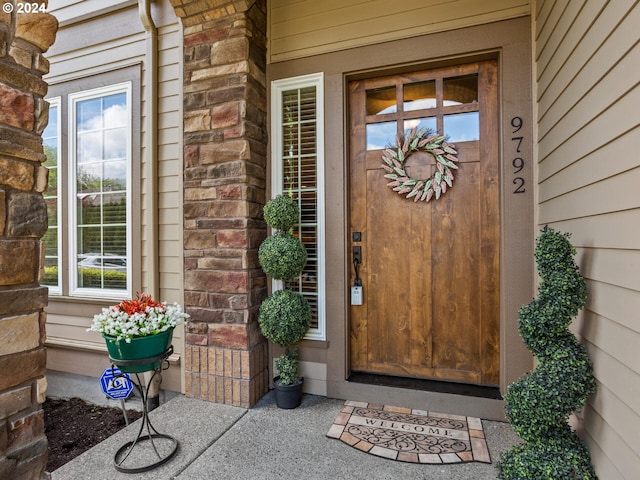 view of exterior entry with brick siding