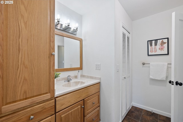 1013 NE Birchwood Dr, Hillsboro, OR 97124 - bathroom featuring a closet, vanity, and baseboards