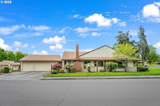 15625 SW Greens Way, Tigard, OR 97224 - ranch-style home featuring a garage, concrete driveway, a front lawn, and a chimney