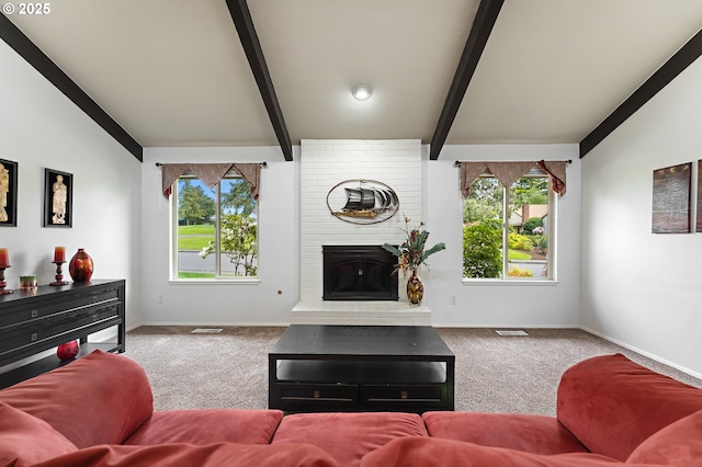 carpeted living room with vaulted ceiling with beams, baseboards, a wealth of natural light, and a fireplace