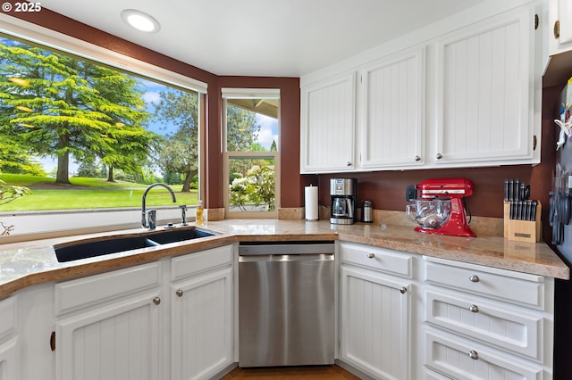 kitchen featuring a sink, white cabinetry, dishwasher, and light countertops