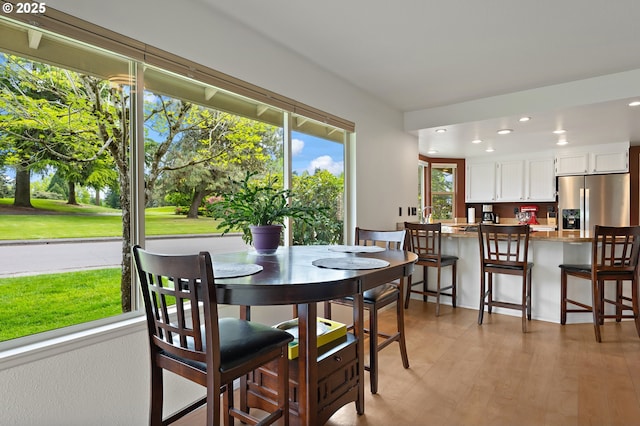 dining space featuring recessed lighting and light wood-style floors