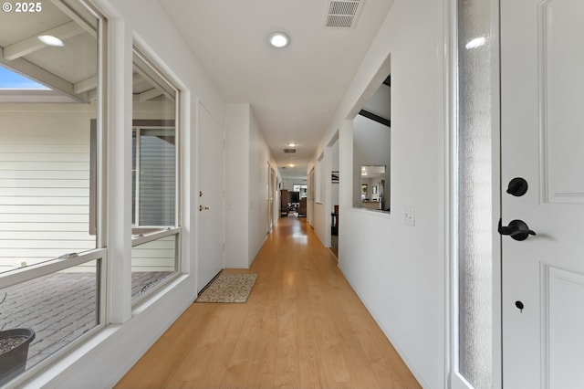 corridor with light wood-style floors, recessed lighting, and visible vents