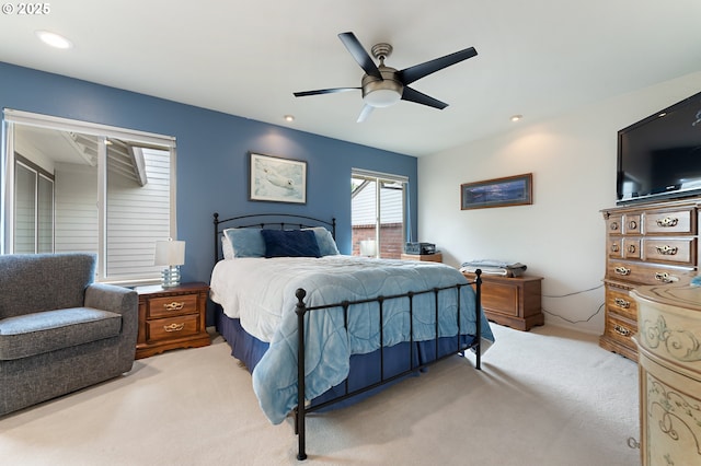 bedroom with a ceiling fan, recessed lighting, and light carpet