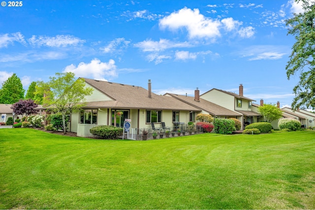 rear view of house with a lawn