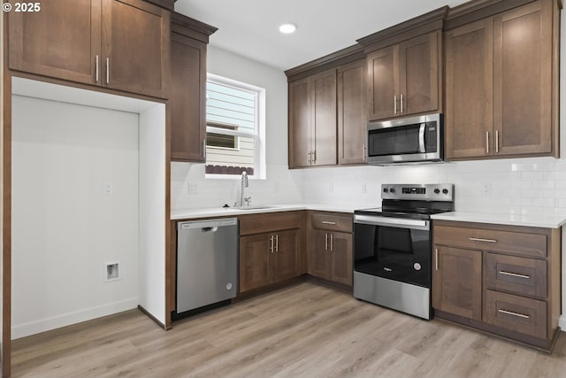 1912 NW 18th Ave, Battle Ground, WA 98604 - kitchen featuring light countertops, a sink, stainless steel appliances, and decorative backsplash